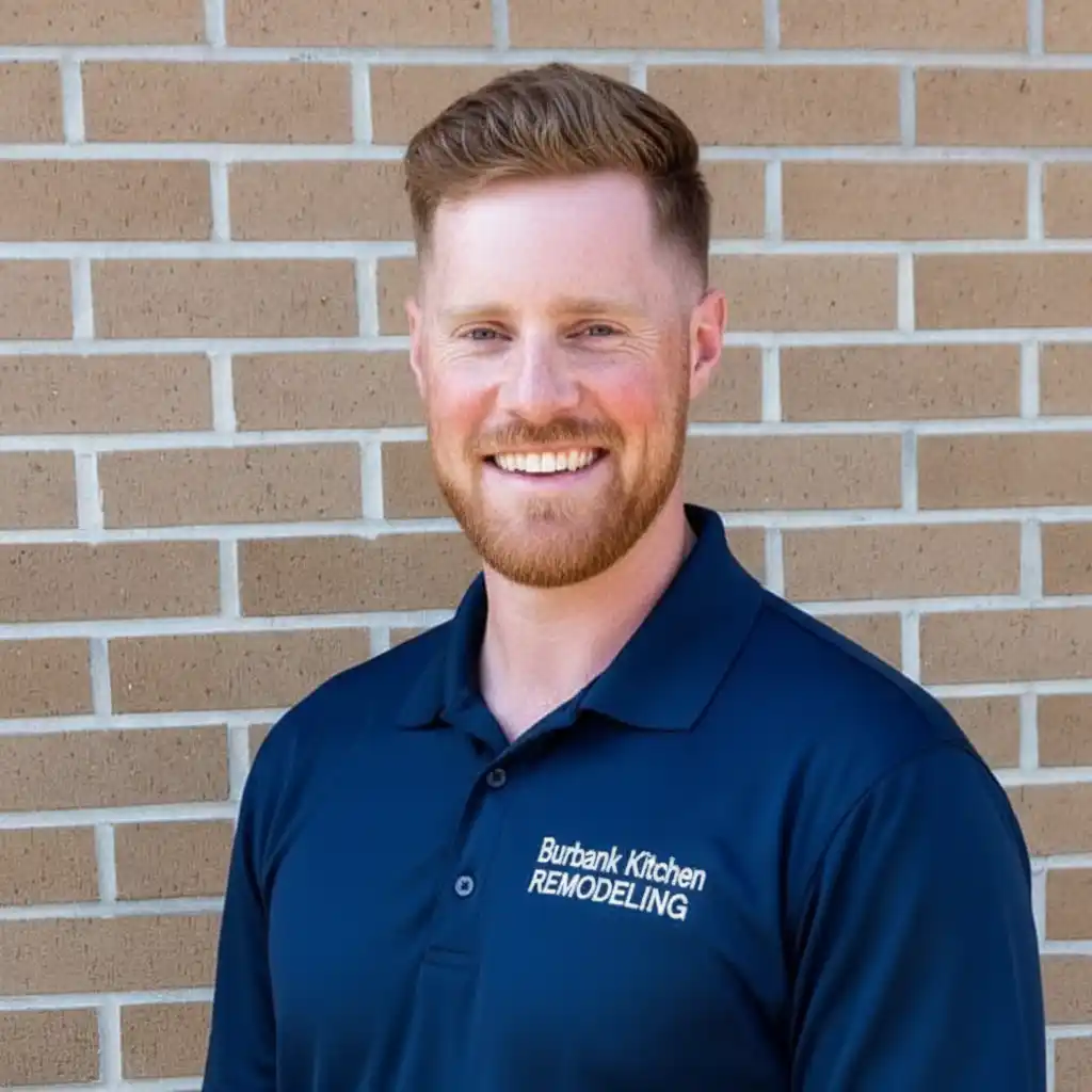 Brandon Myers, owner of Burbank Kitchen Remodeling, standing in front of company signage